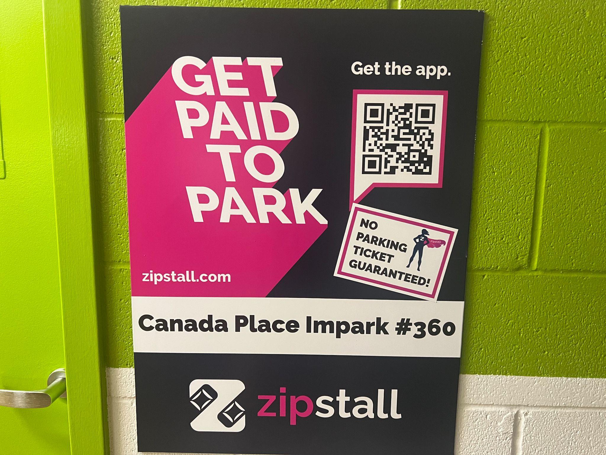  Sign with QR code for Zipstall app in the Canada Place North parkade by the elevators