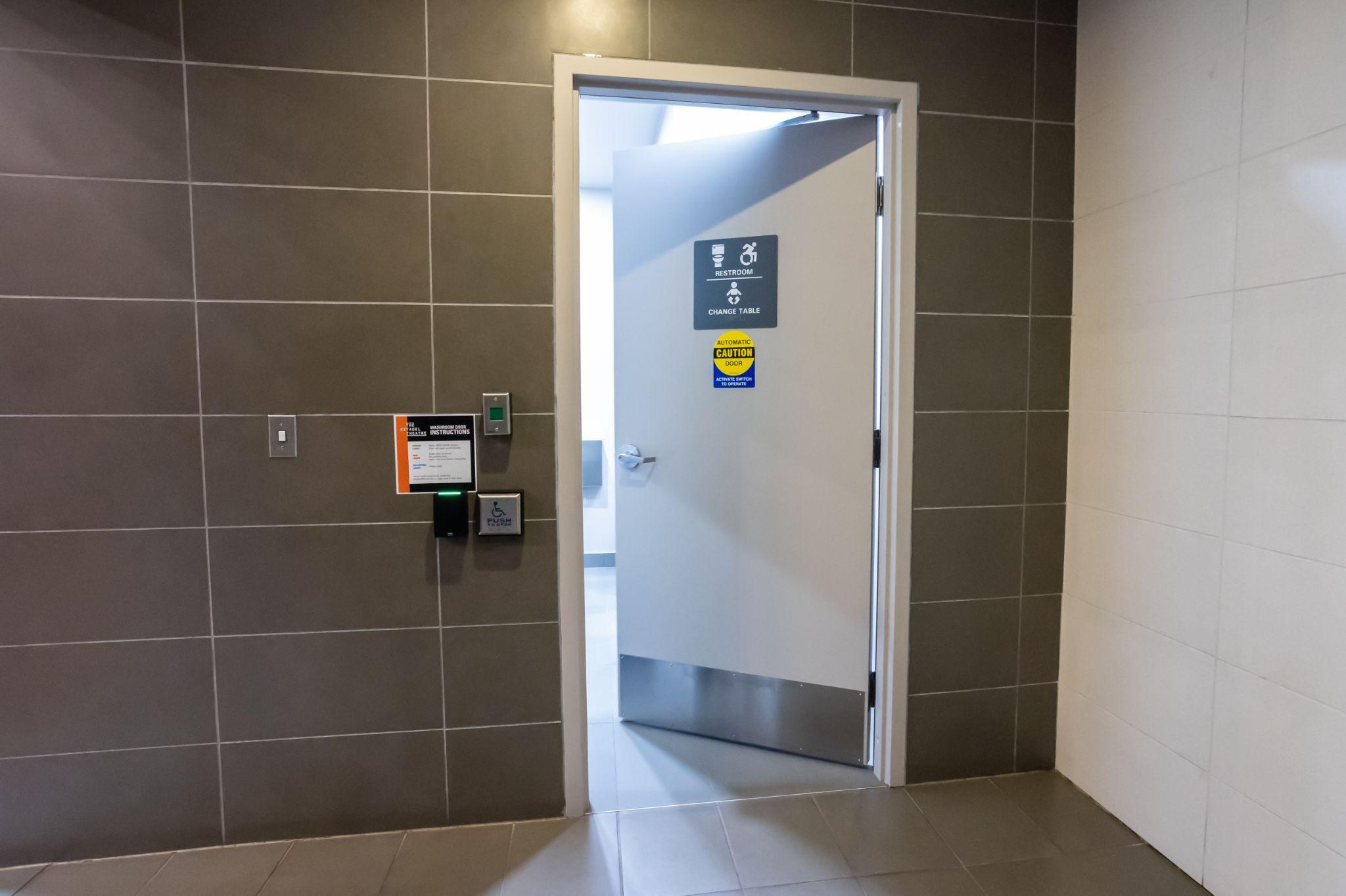 View as door opens into accessible washroom on main floor. There is a wave switch by the door.